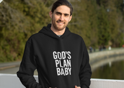 Man wearing a black hoodie with 'GOD'S PLAN BABY' text outdoors.
