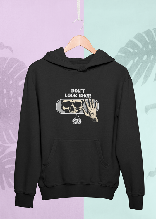 Black hoodie with graphic design on a hanger against a multicolored leaf-patterned background